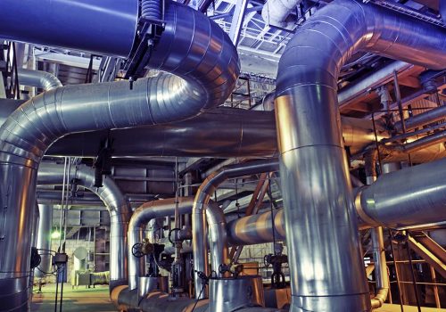 Equipment, cables and piping as found inside of a modern industrial power plant
