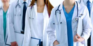 Portrait of group of smiling hospital colleagues standing together .