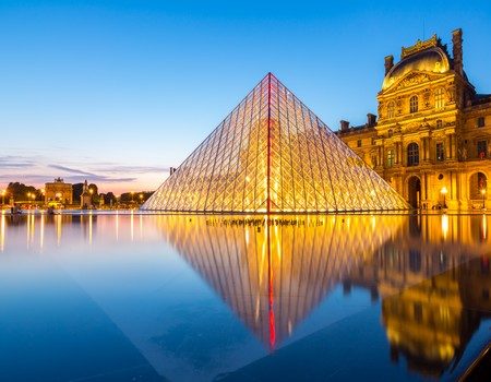 Paris - June 18: Louvre museum at dusk on June 18, 2014 in Paris. This is one of the most popular tourist destinations in France displayed over 60,000 square meters of exhibition space..